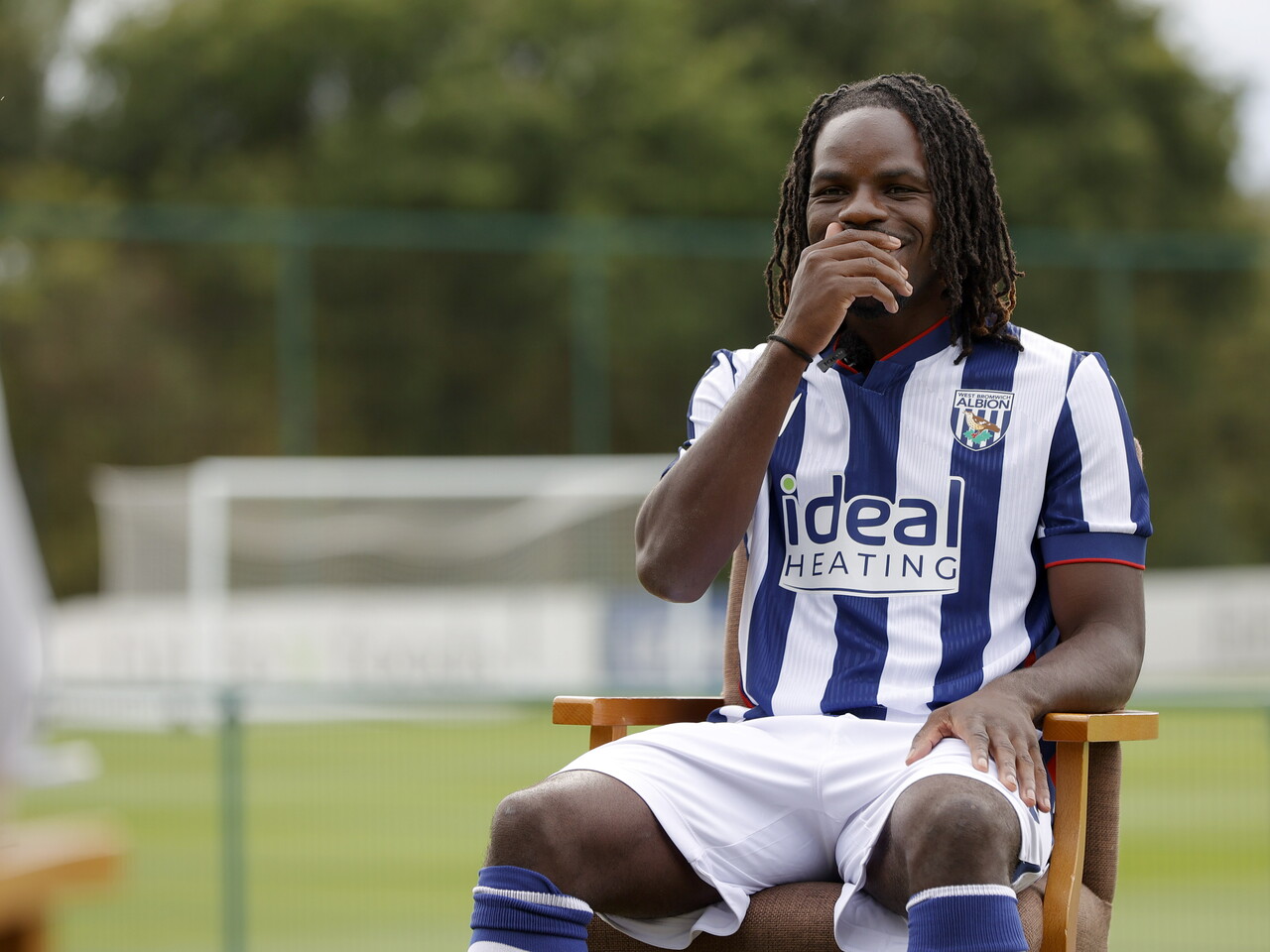 Brayann Pereira sat in a chair in the home kit while being interviewed by WBA TV