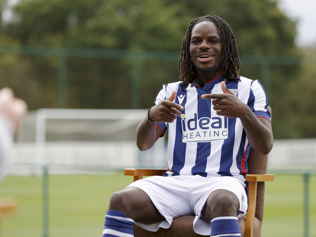 Brayann Pereira sat in a chair in the home kit while being interviewed by WBA TV