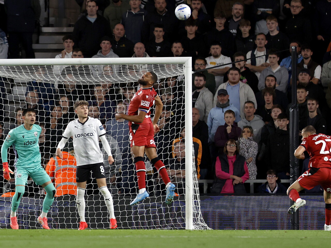 George Campbell heads the ball against Derby County