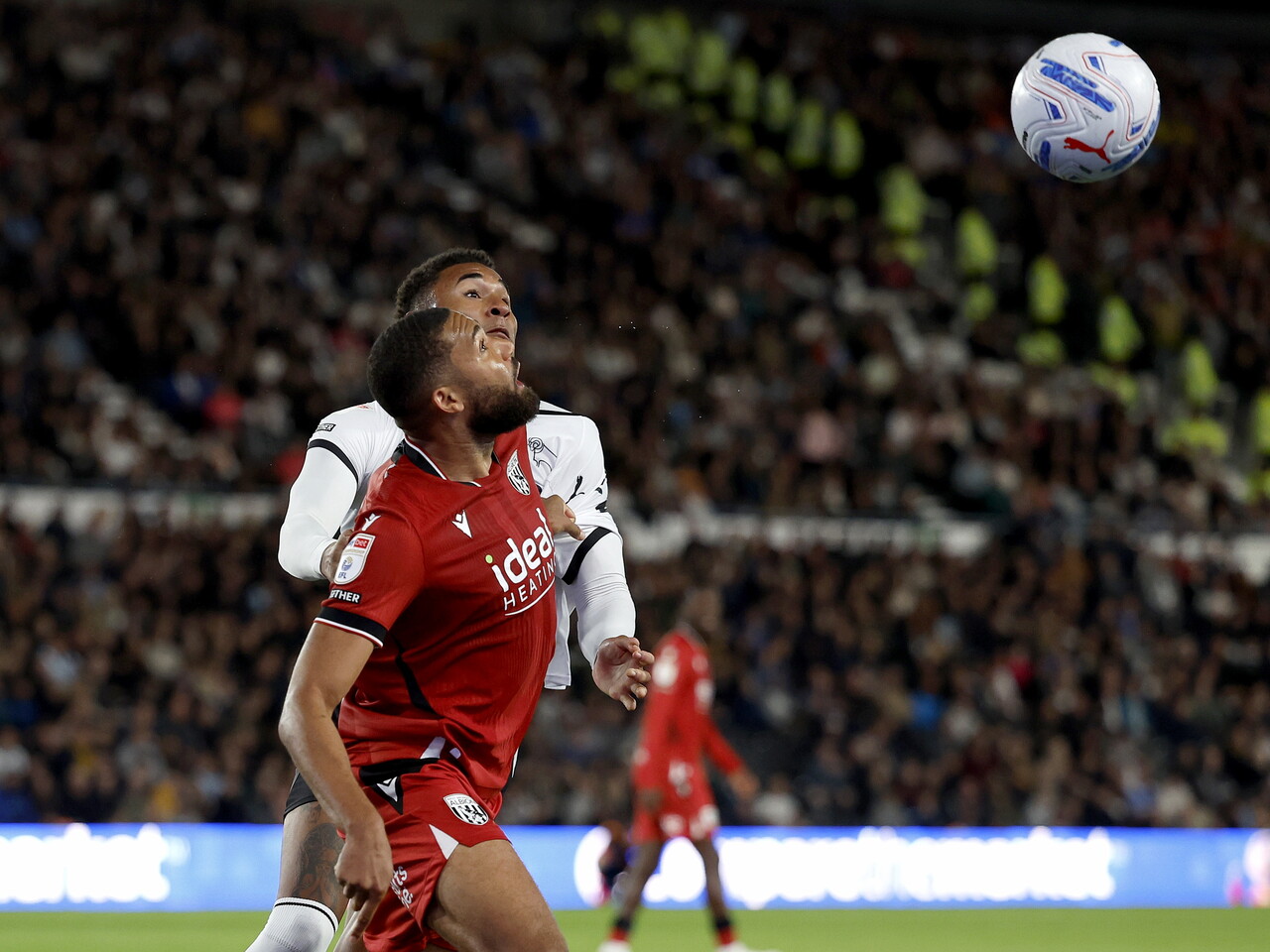 George Campbell heads the ball against Derby County
