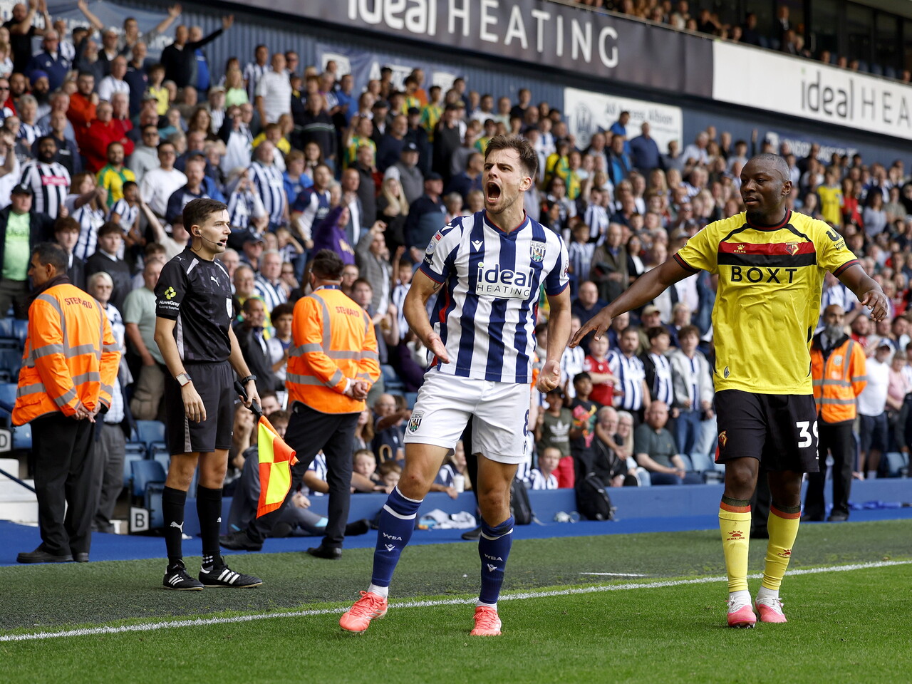 Jayson Molumby cheers with the crowd against Watford
