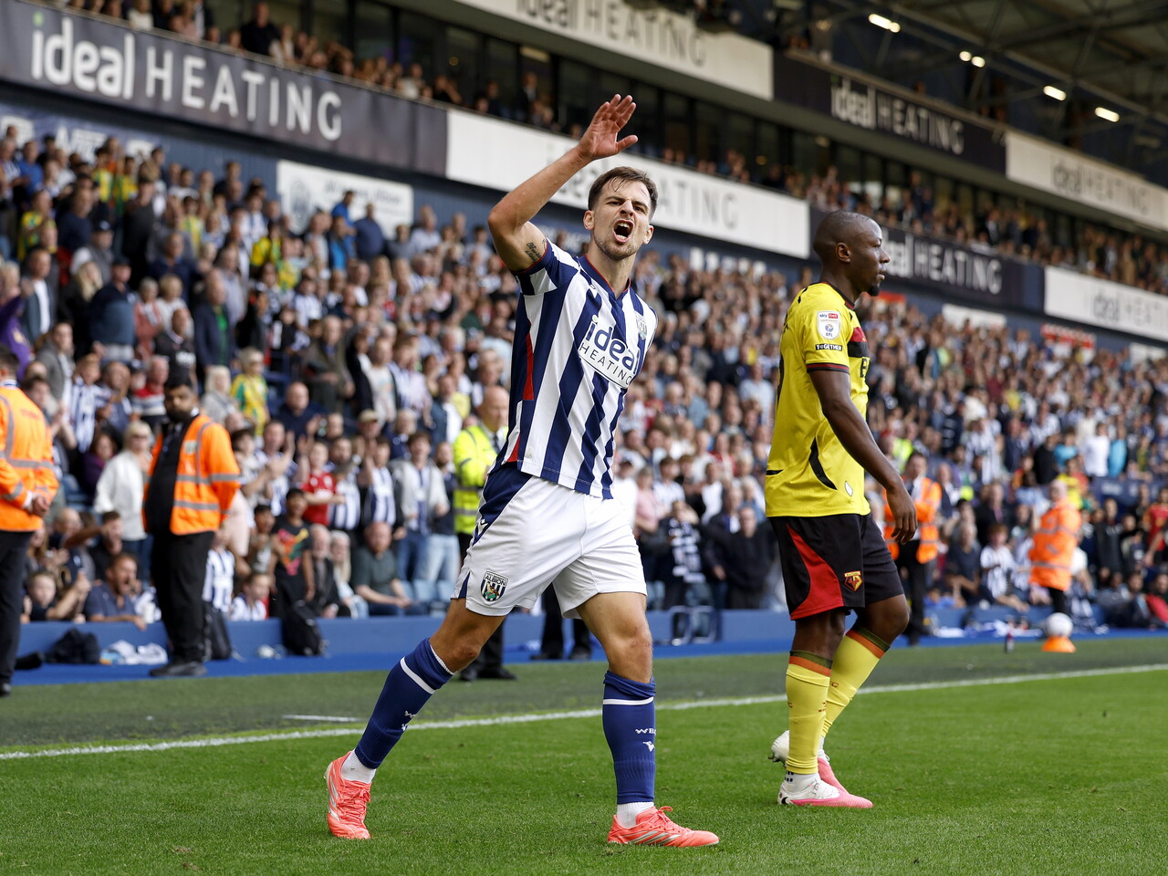 Jayson Molumby cheers with the crowd against Watford