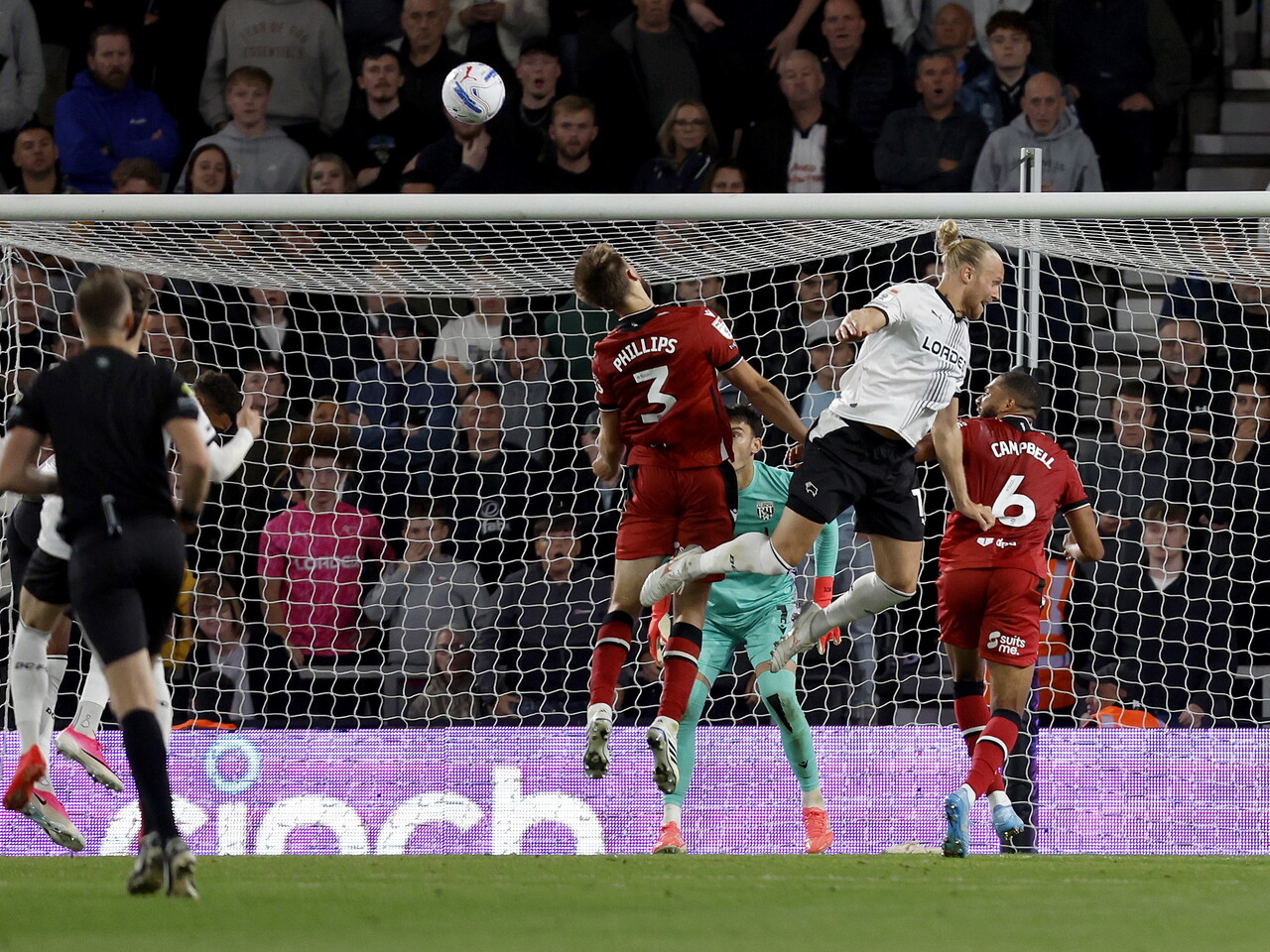 Nat Phillips heads the ball clear against Derby County