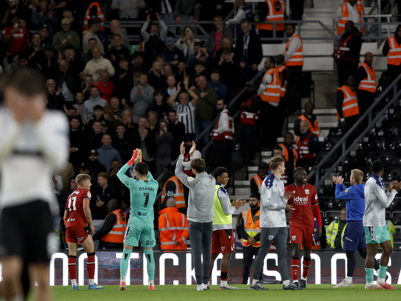 The team applaud the away fans at Derby