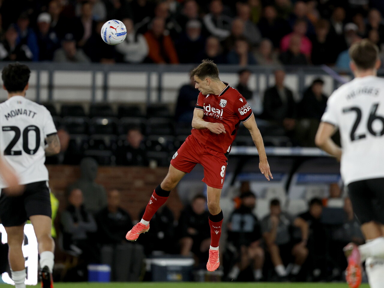 Jayson Molumby heads the ball against Derby County