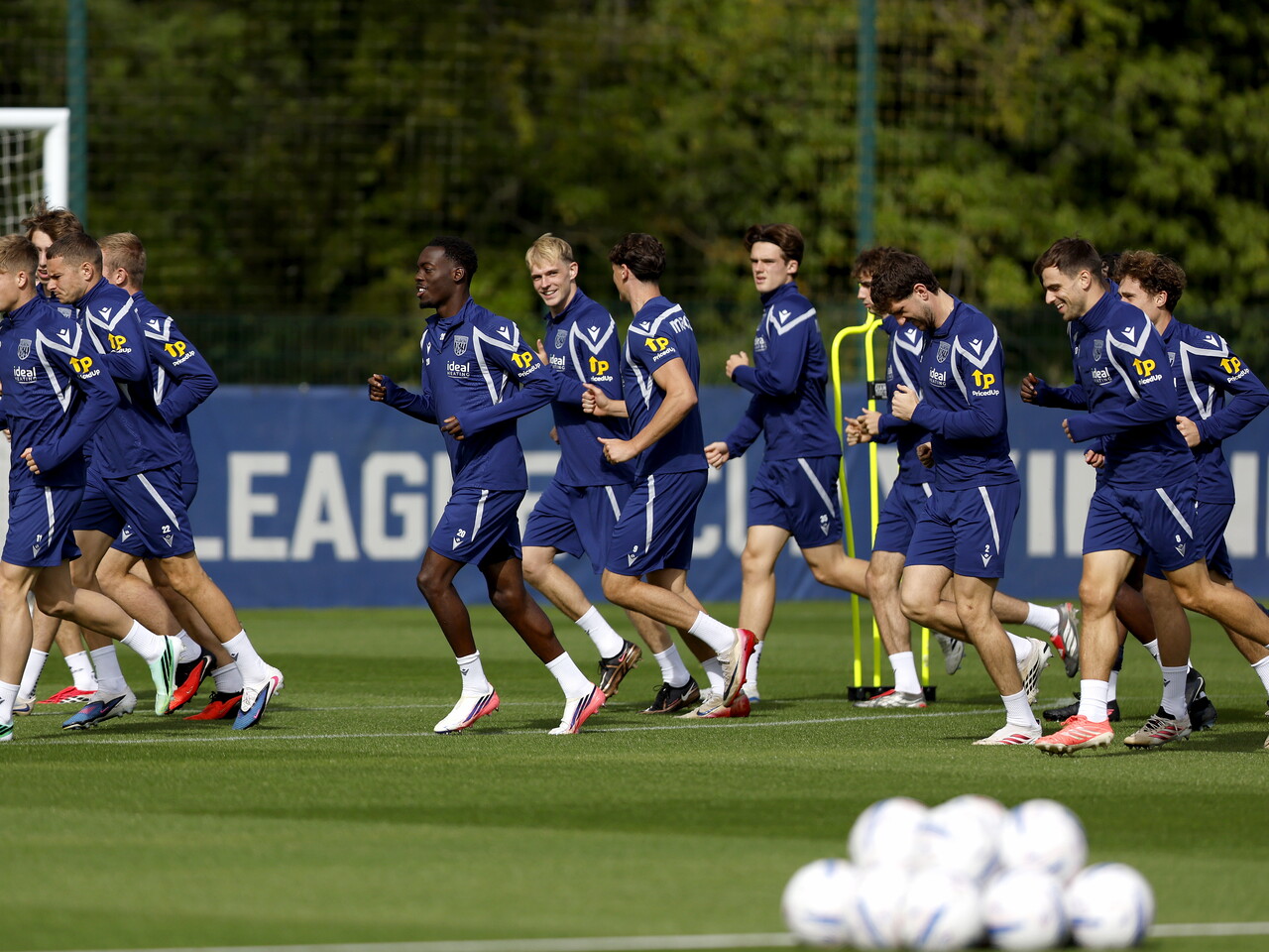 WBA squad jogging round the pitch before a training session