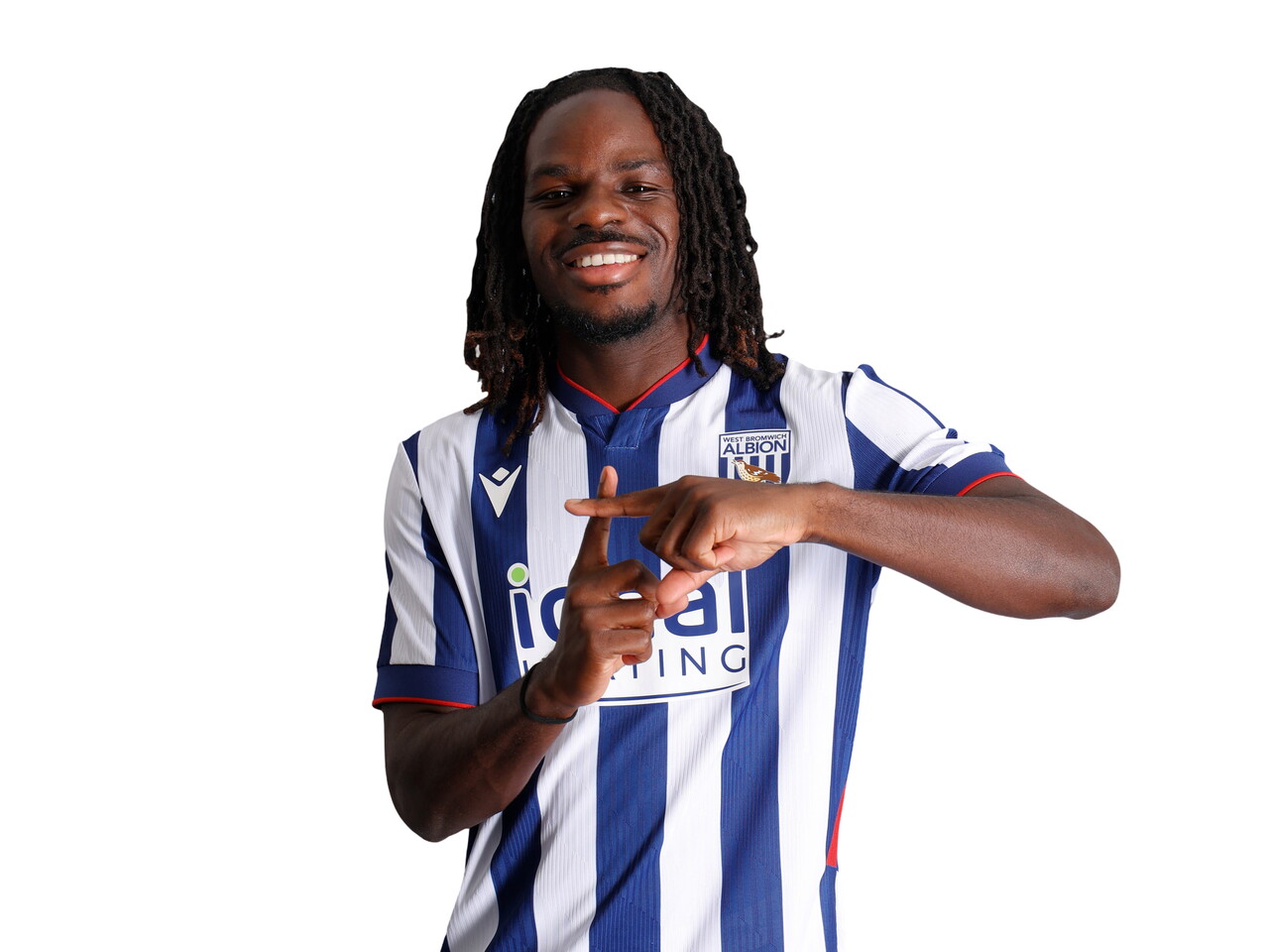 Brayann Pereira smiling at the camera while stood in the home kit