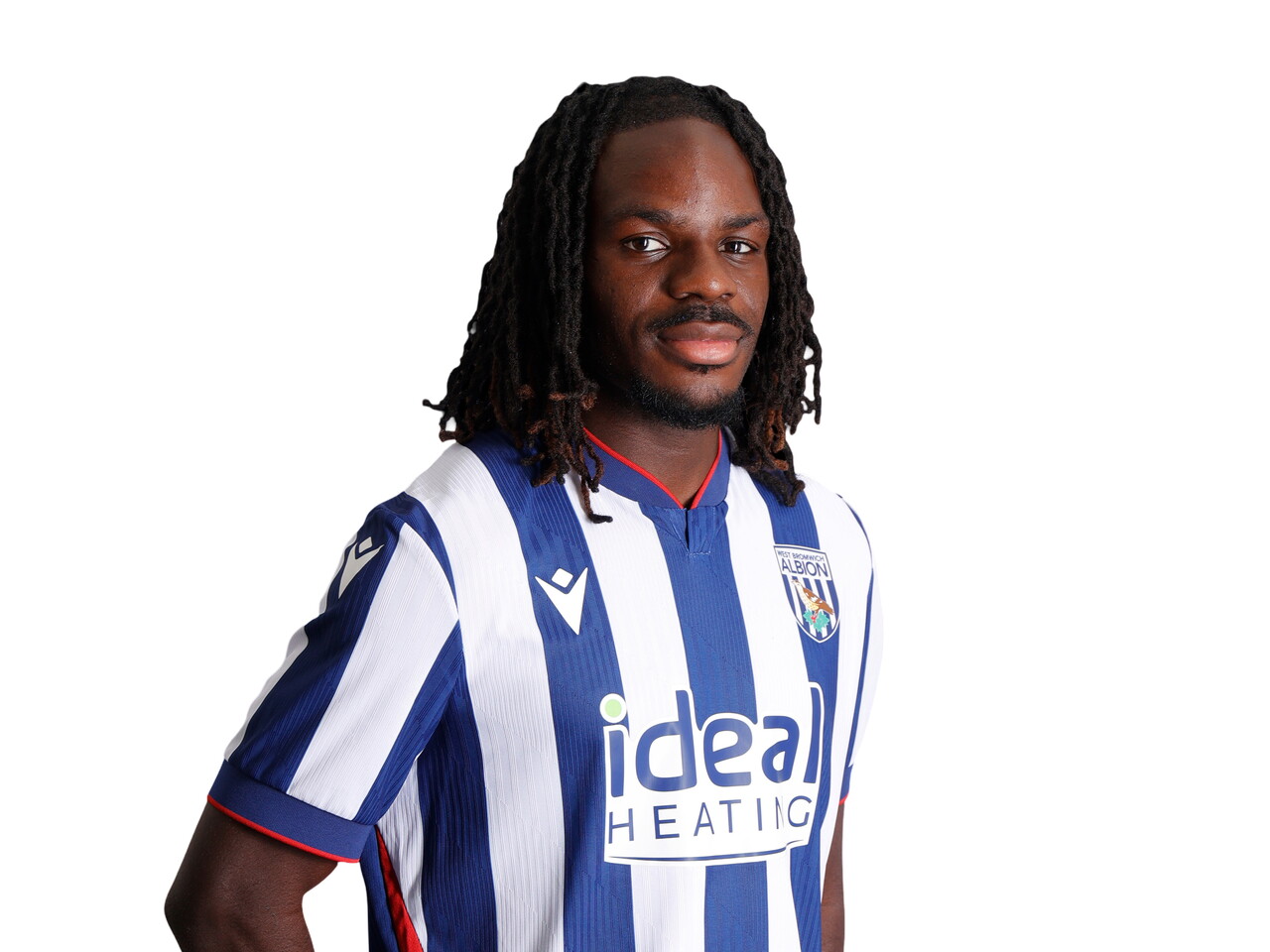 Brayann Pereira smiling at the camera while stood in the home kit