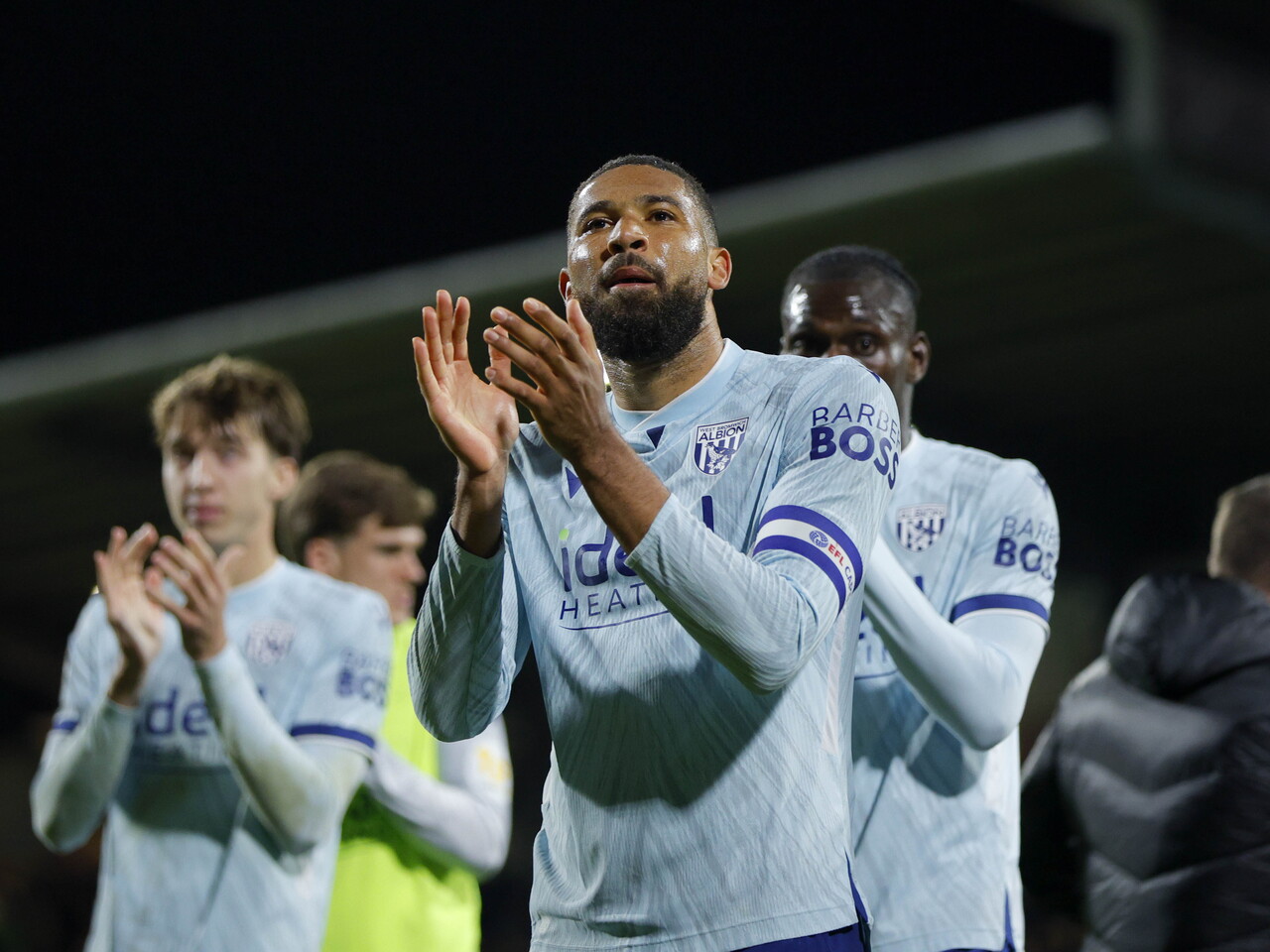 George Campbell applauds the fans at full-time