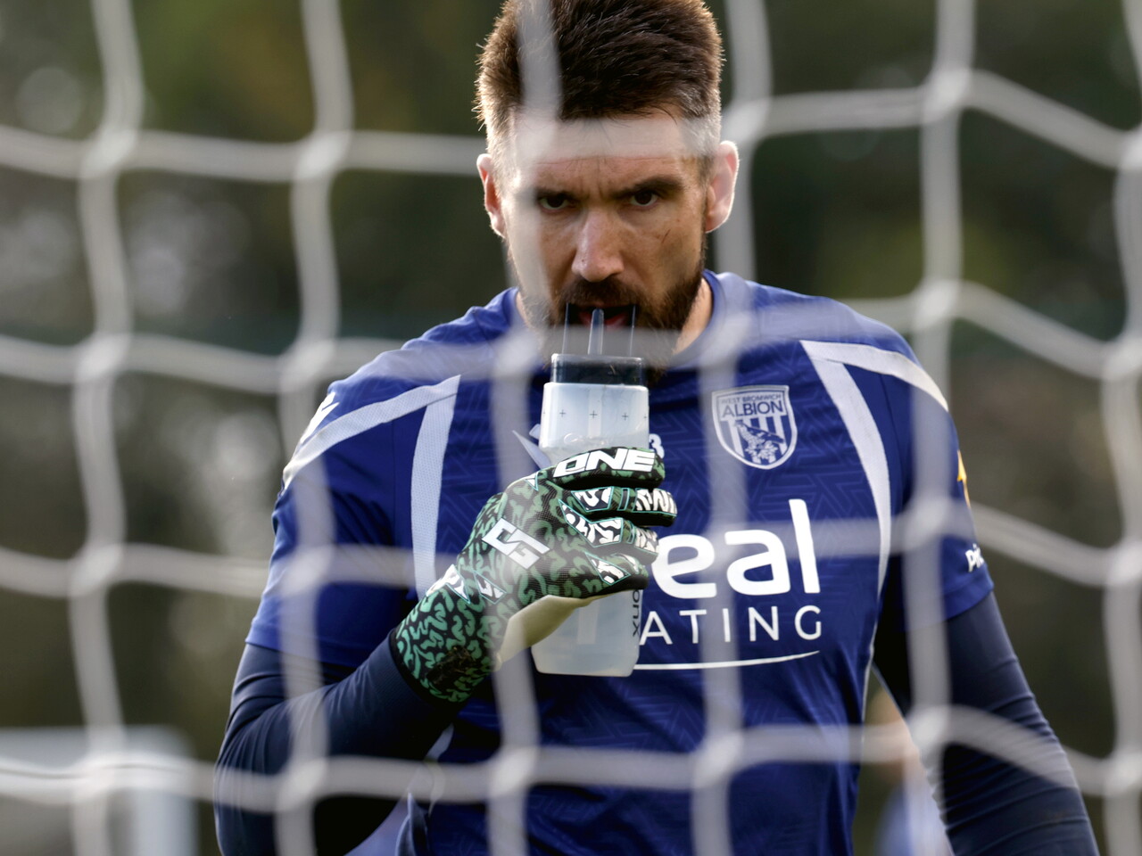 Matt Ingram taking a sip out of his water bottle during a training session