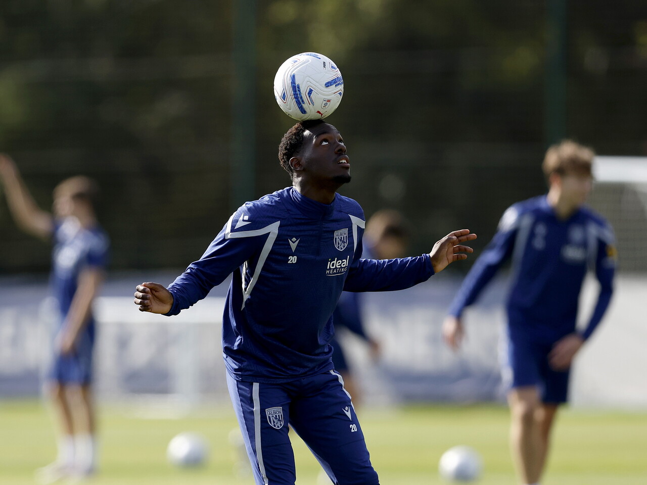 Rabby Nzingoula balancing the ball on his head during a training session