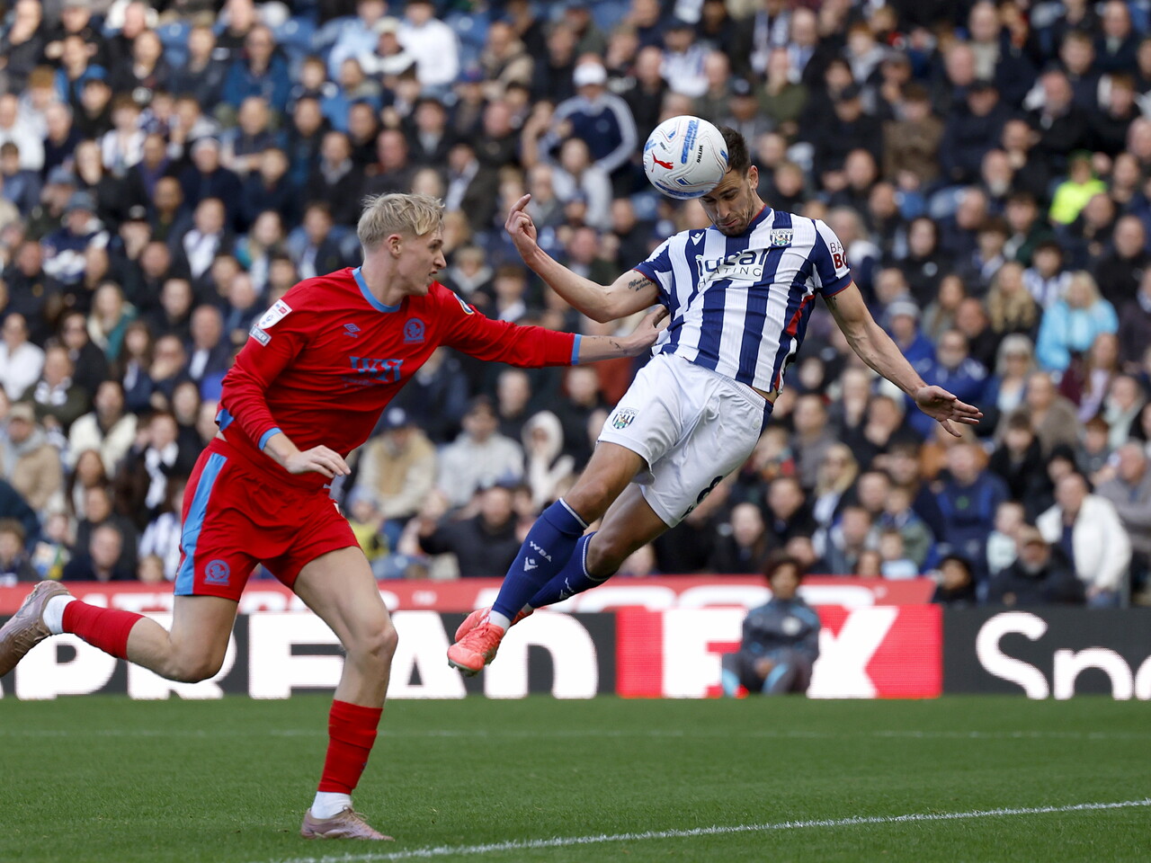 Jayson Molumby heads the ball against Blackburn