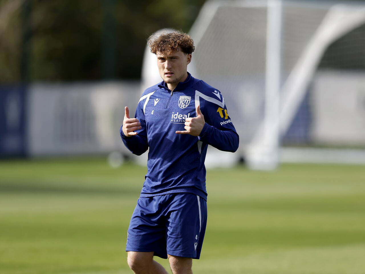 Callum Styles looking towards the camera and holding his thumbs up during a training session