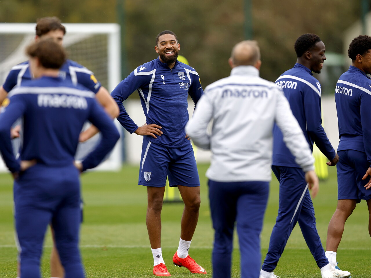 George Campbell smiling during a training session with his hands on his hips