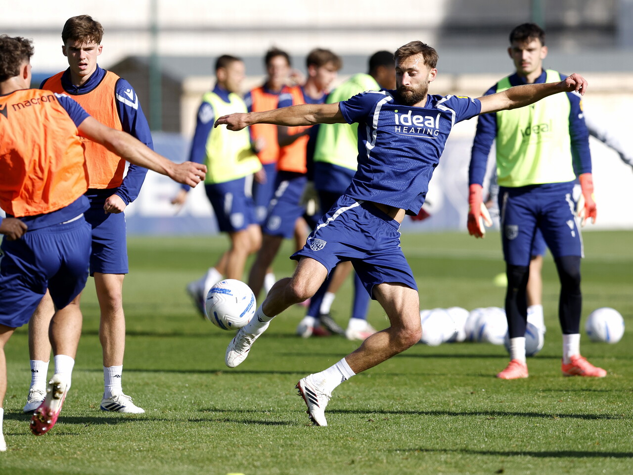 Nat Phillips stretching to win the ball during a training session
