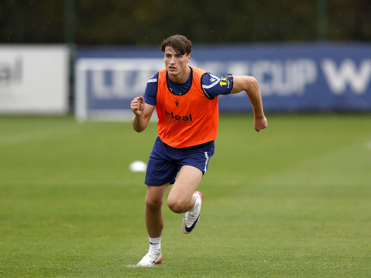 Barney Stewart running towards the ball during training 