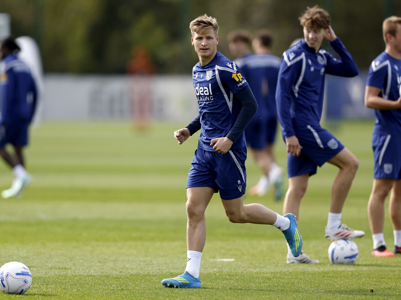 JJ Morgan running with the ball during a training session