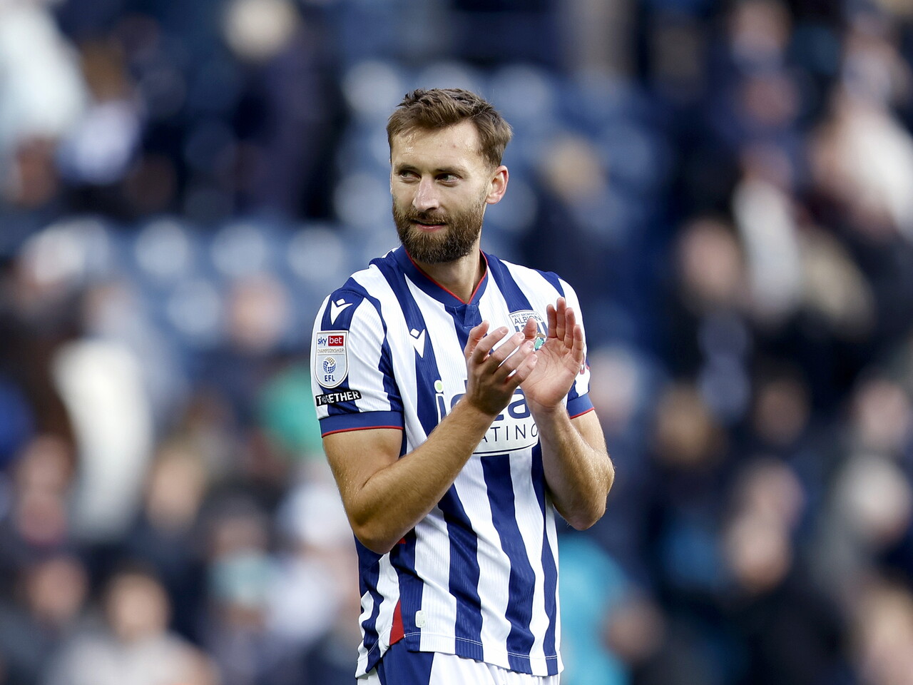 Nat Phillips applauds the fans at full-time