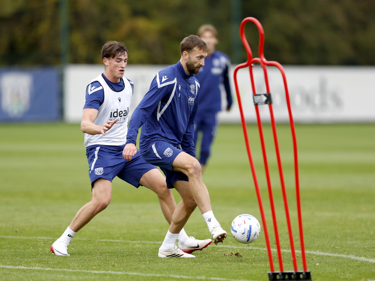 Nat Phillips on the ball with Barney Stewart applying pressure during training 