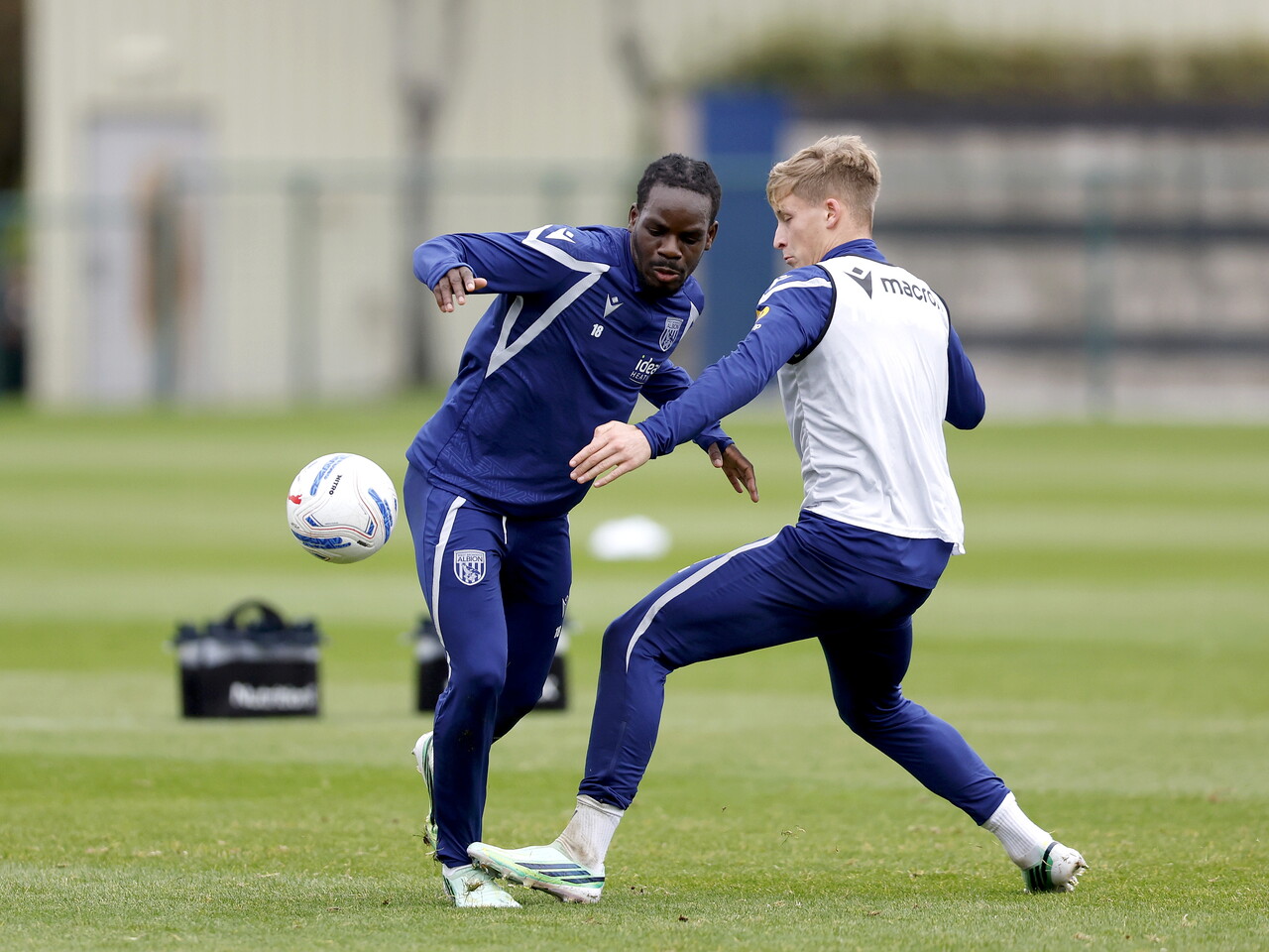 Brayann Pereira and JJ Morgan battle for the ball during training 