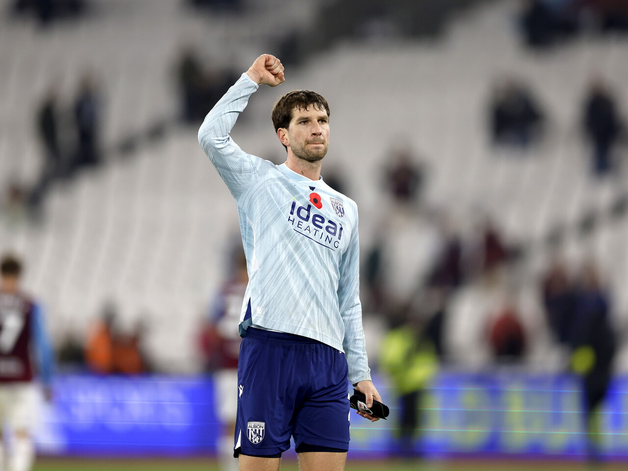 Chris Mepham waves to the fans at full-time