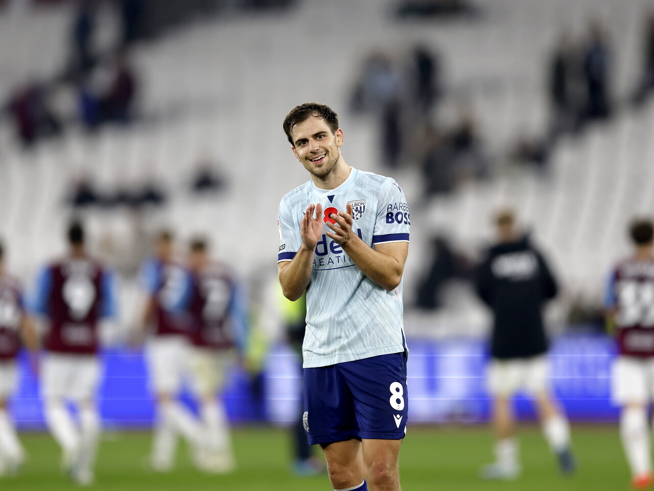 Jayson Molumby applauds the fans at full-time