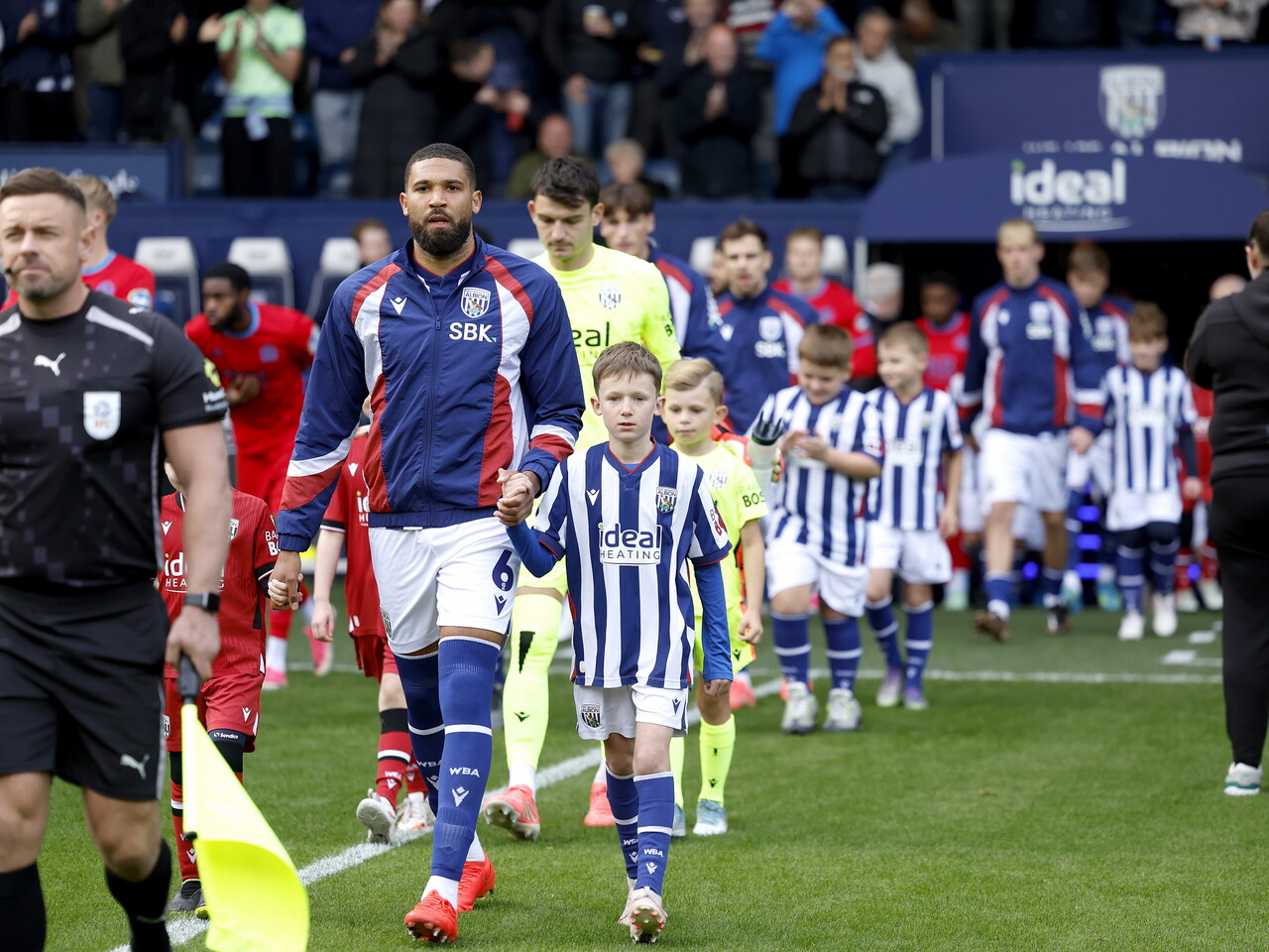 George Campbell leads Albion out at the start of the game