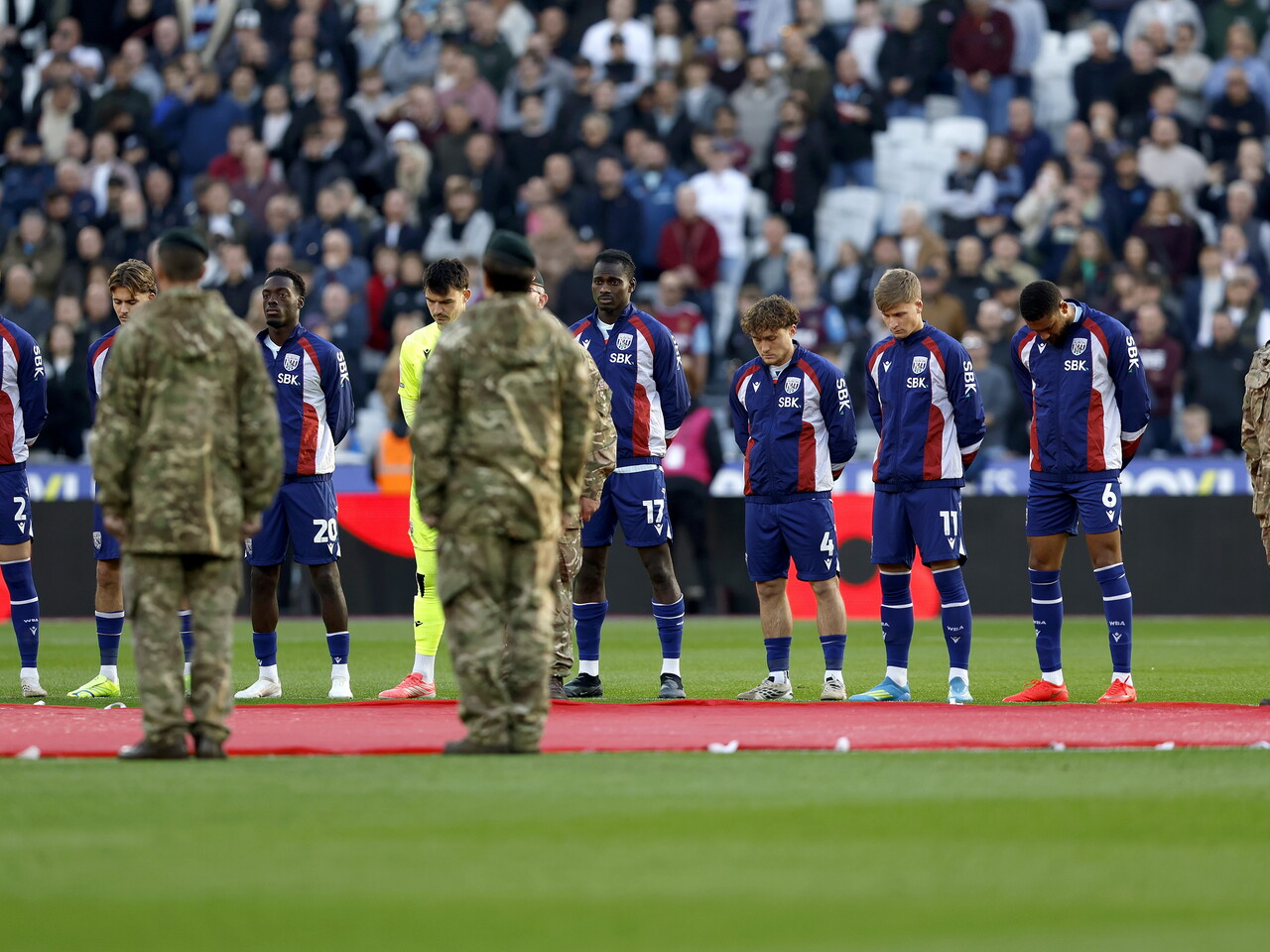 The Albion players join in a minute's silence for Remembrance