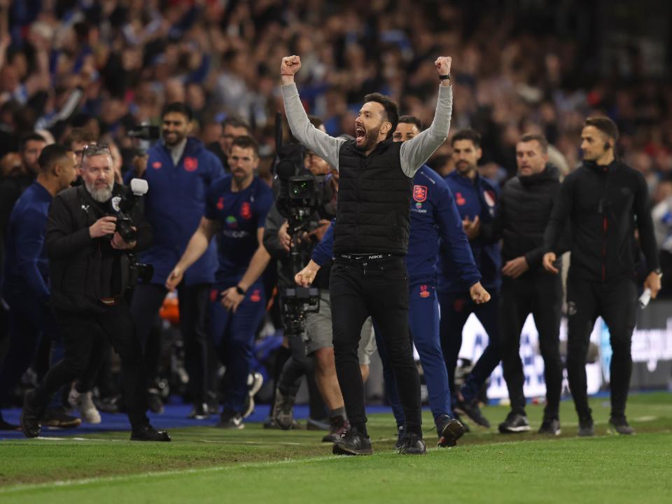 An image of new Albion boss Carlos Corberan celebrating a win while Huddersfield manager