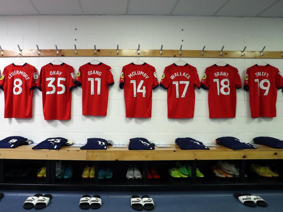Albion's red shirts hang up in the dressing room at Huddersfield Town