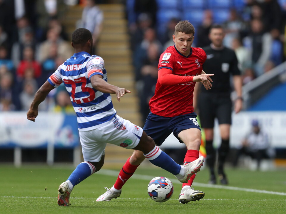 An image of Conor Townsend trying to beat a Reading defender