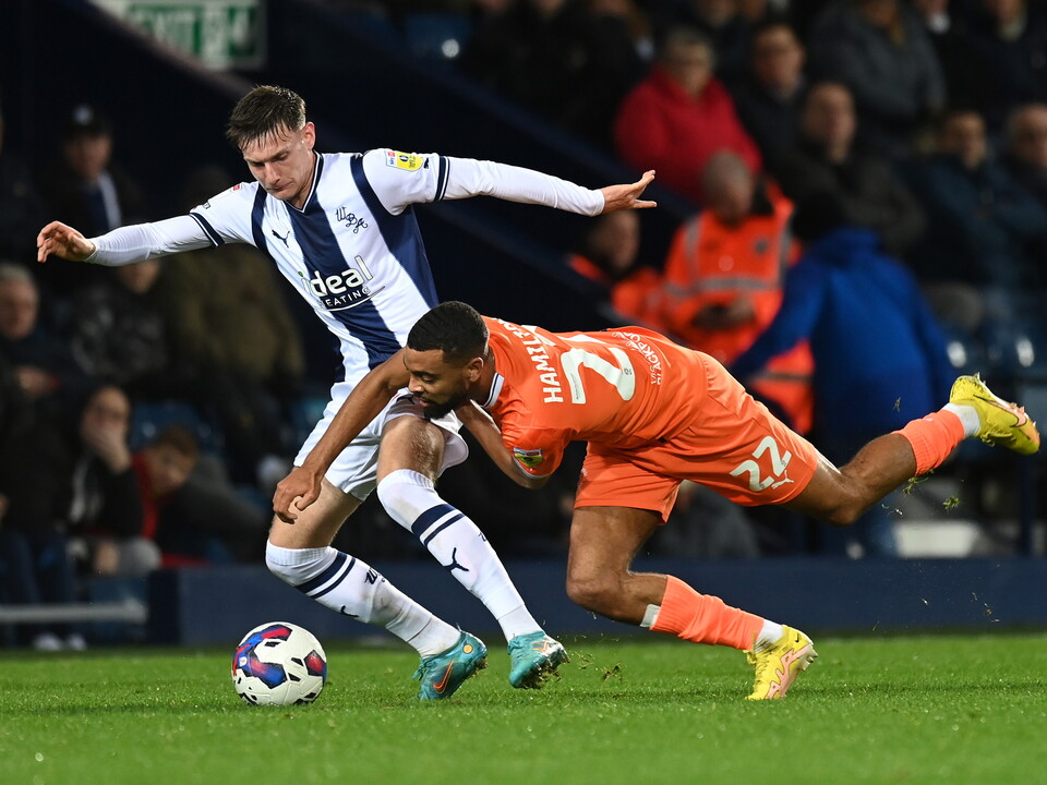 Taylor Gardner-Hickman battles for the ball in Albion v Blackpool match