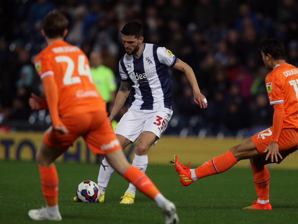 An image of Okay Yokuslu playing a pass against Blackpool