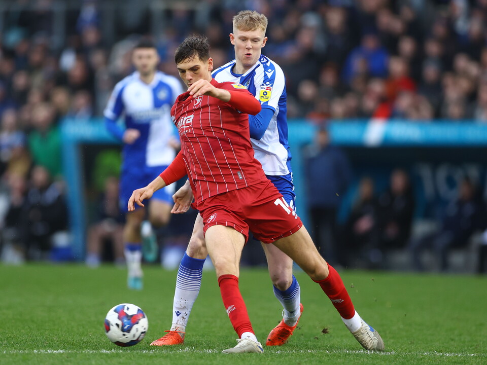 Albion youngster Caleb Taylor holds off Josh Coburn for loan club Cheltenham Town during their game with Bristol Rovers