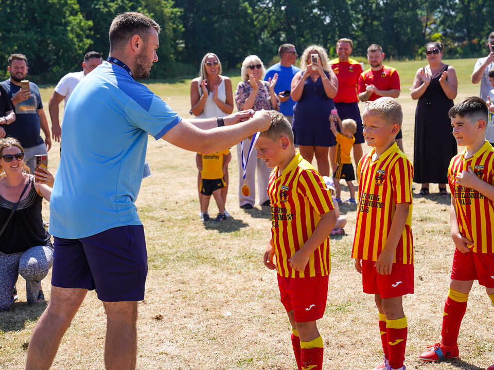 Foundation staff, handing out winners medals.