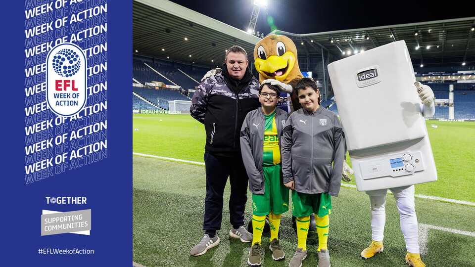 James, Richard and Dad standing with Baggie Bird and Boiler Man pitch side