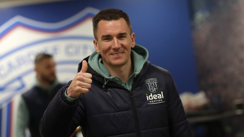 Jed Wallace gives the thumbs up sign as Albion players arrive at Cardiff