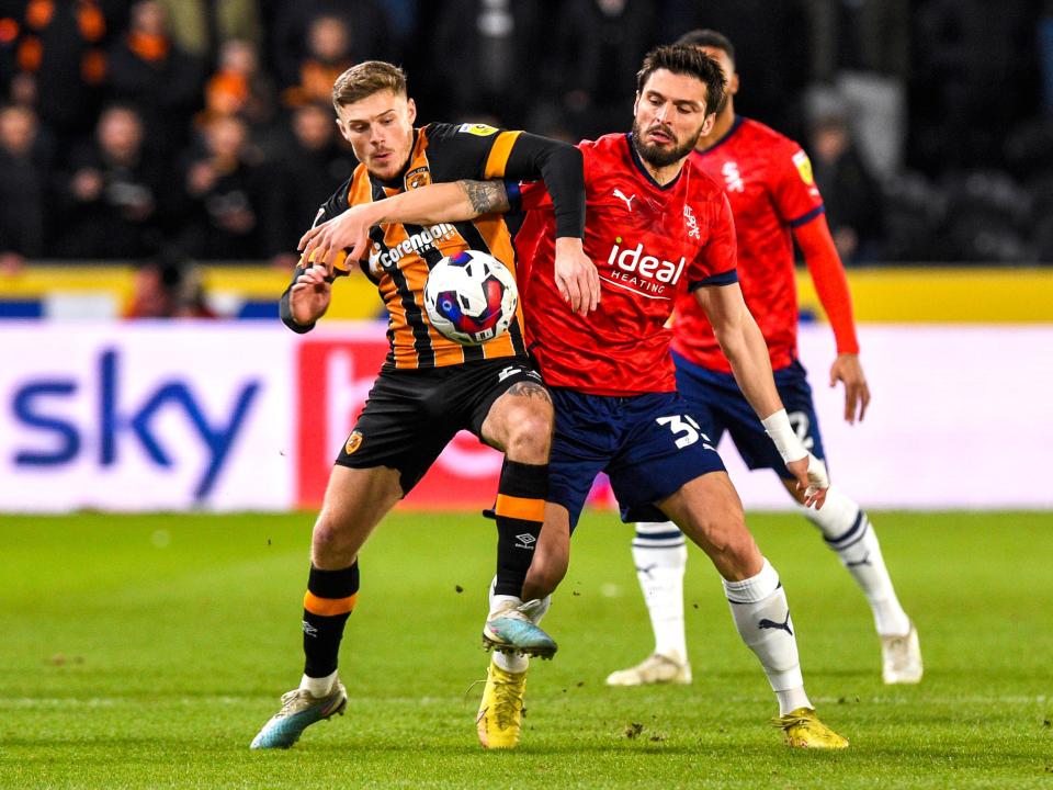 An image of Okay Yokuslu battling against a Hull player