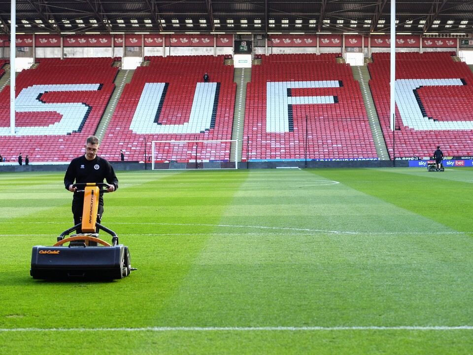 A groundsman attends to the pitch at Bramall Lane