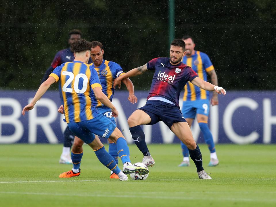 An image of Okay Yokuslu tackling a Shrewsbury player