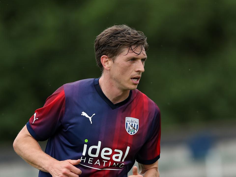 Adam Reach in action wearing the club's navy and red away kit