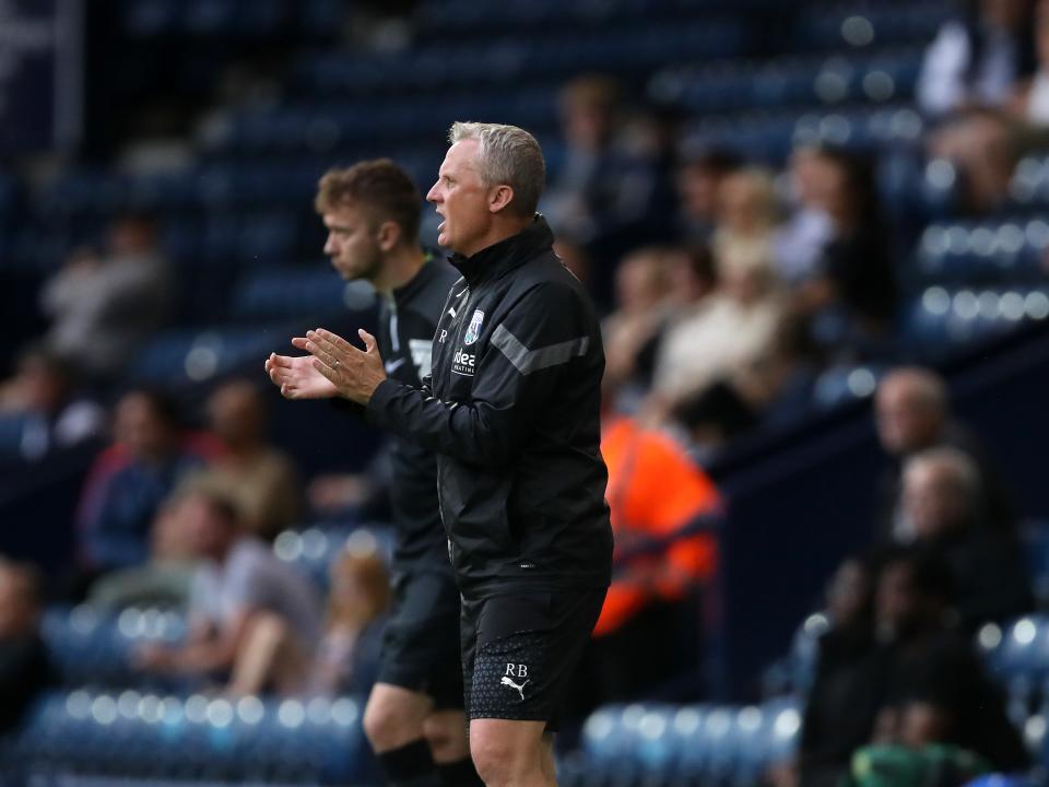 A photo of U21s boss Richard Beale encouraging his team on from The Hawthorns' home dugout during Albion's PL2 game against Blackburn