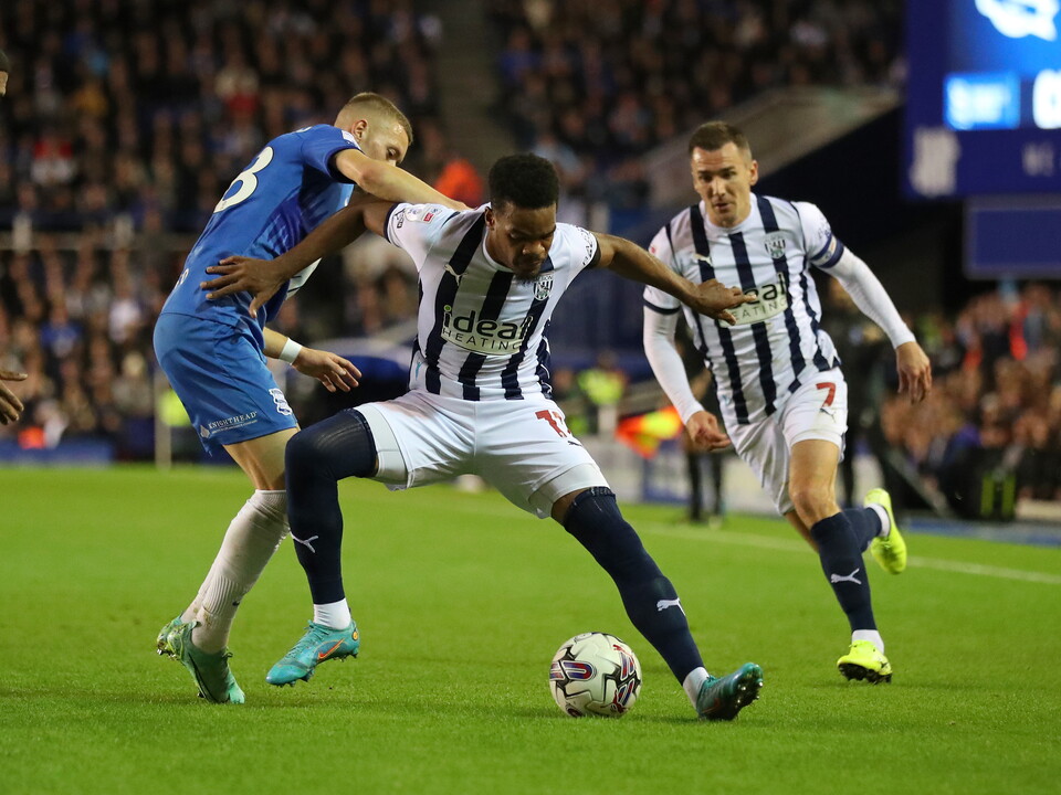 A photo of Grady Diangana in 2023/24 home colours battling for the ball at St. Andrew's against Birmingham City