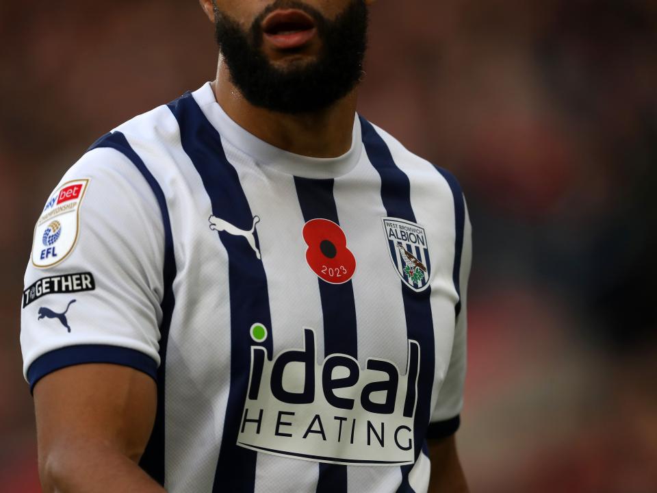 Matty Phillips wearing a poppy on his shirt