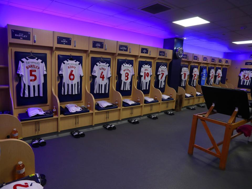 An image of shirts hanging up in the dressing room