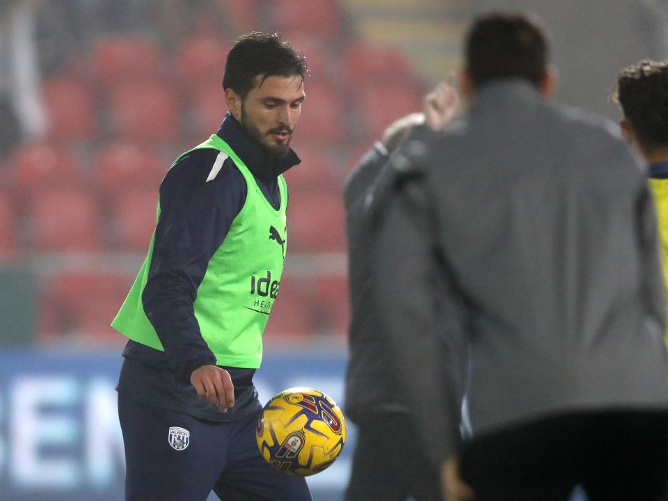 An image of Okay Yokuslu warming up against Rotherham