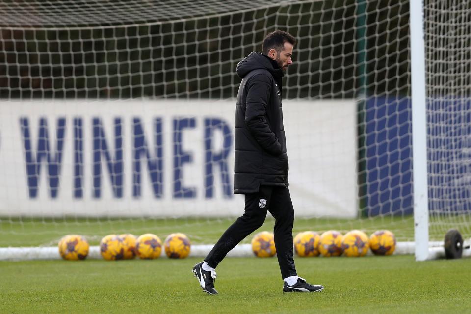 Carlos Corberán in a coat on the training pitch