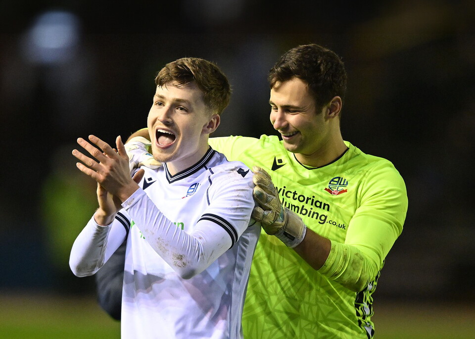 A photo of Zac Ashworth applauding Bolton fans after helping his loan team to a win at Carlisle