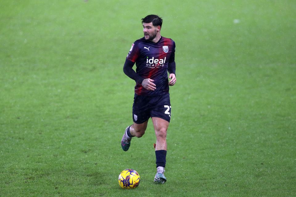 Alex Mowatt in action in the navy-blue-and-red kit at Swansea