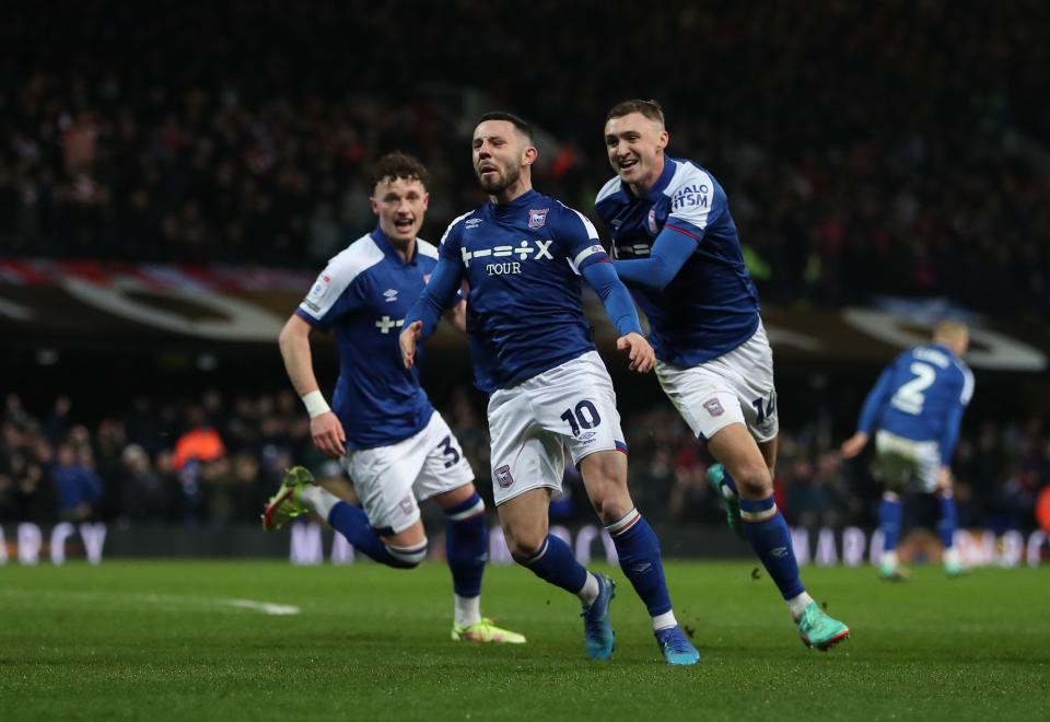 Three Ipswich Town players celebrate a goal scored at their home ground Portman Road